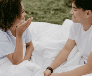couple sitting on blanket outdoors Intimate Questions to Ask Your Partner