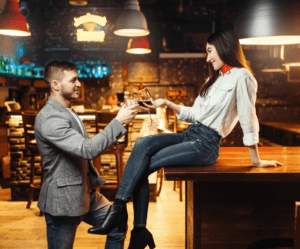 woman sitting on bar man standing Dirty Pick-Up Lines
