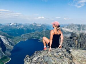 woman sitting on mountain cliff