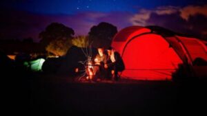 By fire at campsite